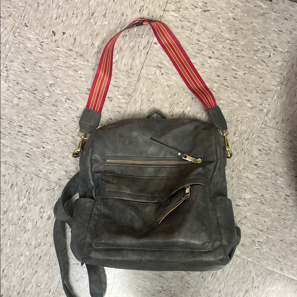 Gray Women's faux leather backpack with vibrant Strap
